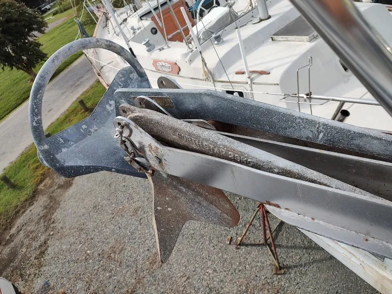 Slide: The Image of Anchor on a 1981 Bruce Roberts 450 sailboat, displayed on a gravel surface. - 19