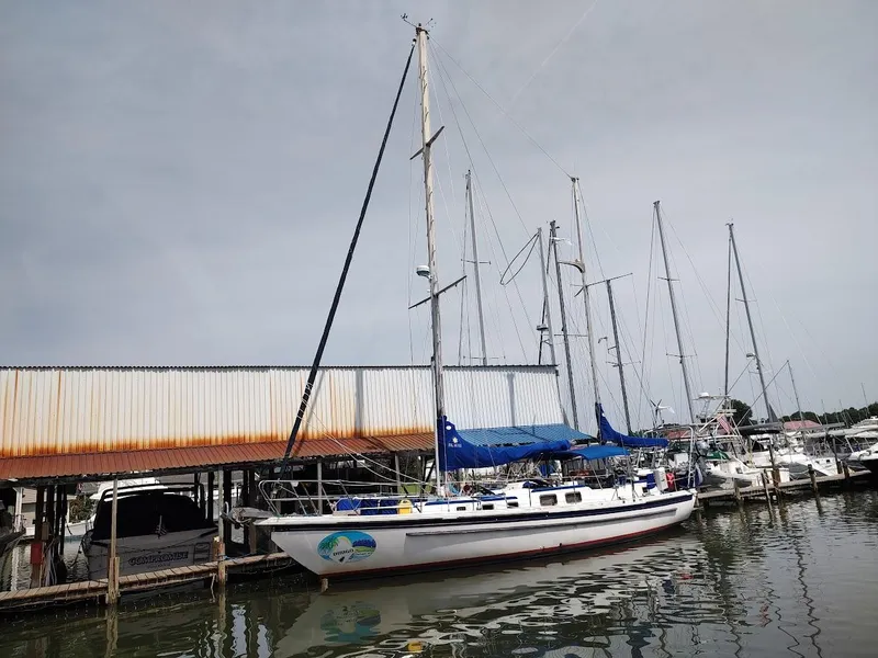 Slide: The Image of 1981 Bruce Roberts 450 sailboat docked at marina, surrounded by other boats. - 2