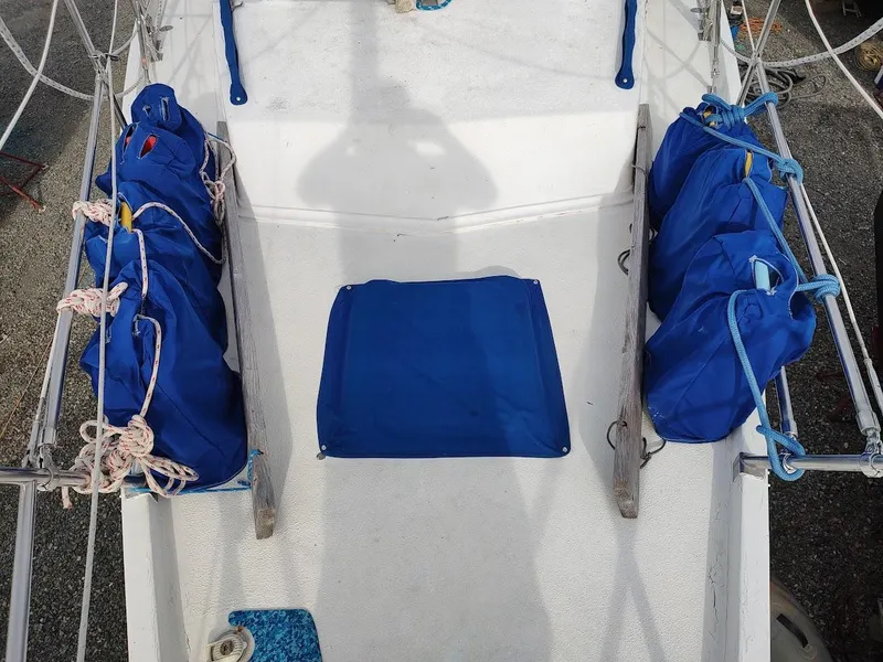 Slide: The Image of Deck of 1981 Bruce Roberts 450 sailboat with blue storage bags and ropes. - 21