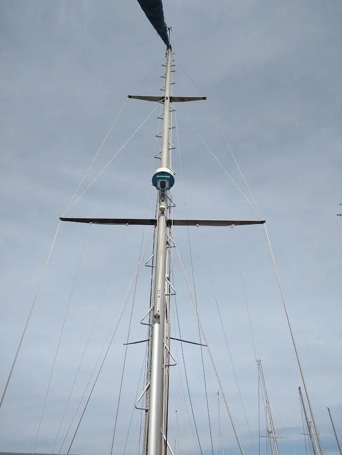 Slide: The Image of Tall sailboat mast of 1981 Bruce Roberts 450 against cloudy sky. - 24