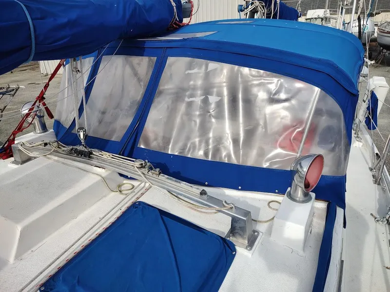Slide: The Image of 1981 Bruce Roberts 450 sailboat with blue canvas cover and clear windows. - 25