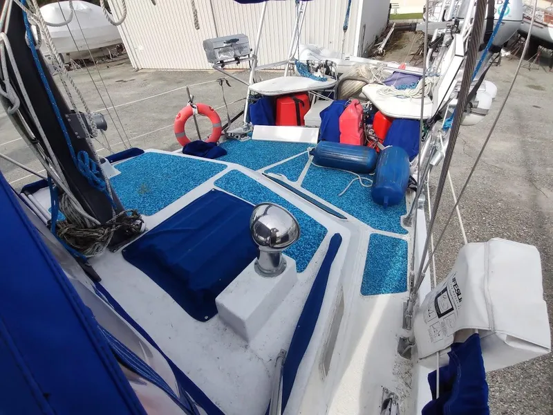 Slide: The Image of Deck of 1981 Bruce Roberts 450 sailboat with blue accents and safety equipment. - 27