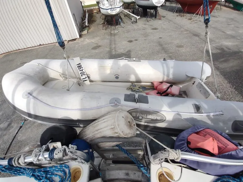 Slide: The Image of Inflatable boat with life jackets and ropes, docked near Bruce Roberts 450, 1981 model. - 31