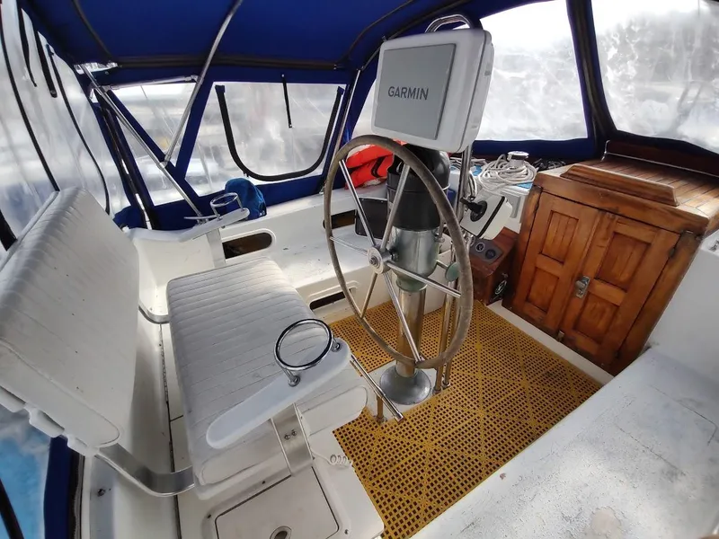 Slide: The Image of Cockpit of 1981 Bruce Roberts 450 sailboat with Garmin navigation system and wooden storage cabinet. - 41