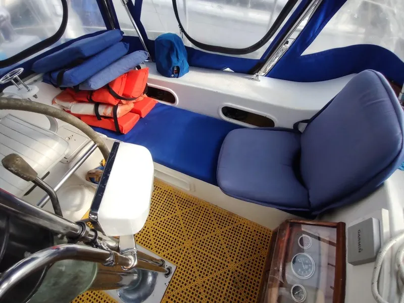 Slide: The Image of Interior of 1981 Bruce Roberts 450 boat with blue seating and life jackets. - 46