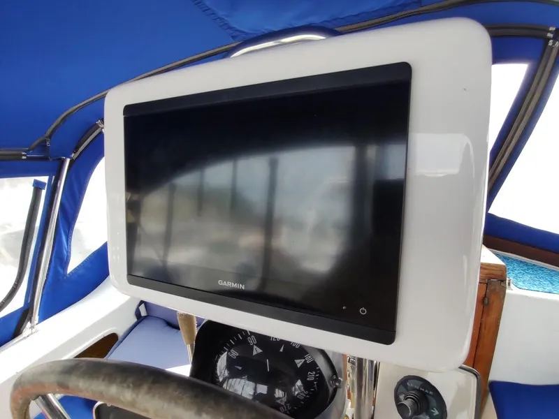 Slide: The Image of Garmin navigation display on 1981 Bruce Roberts 450 boat, with blue canopy background. - 47