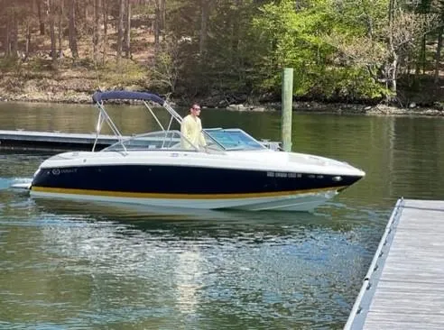 The Image of 2006 Cobalt 24SX boat cruising near a dock on a calm lake. - 0