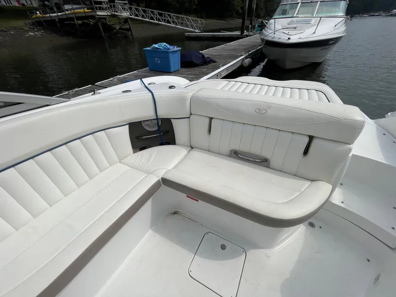 Slide: The Image of 2006 Cobalt 24SX boat with white leather seating at a dock. - 10