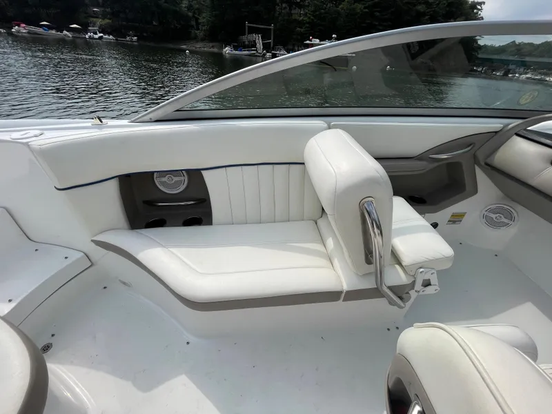 Slide: The Image of 2006 Cobalt 24SX boat interior with white seating and lake view. - 11