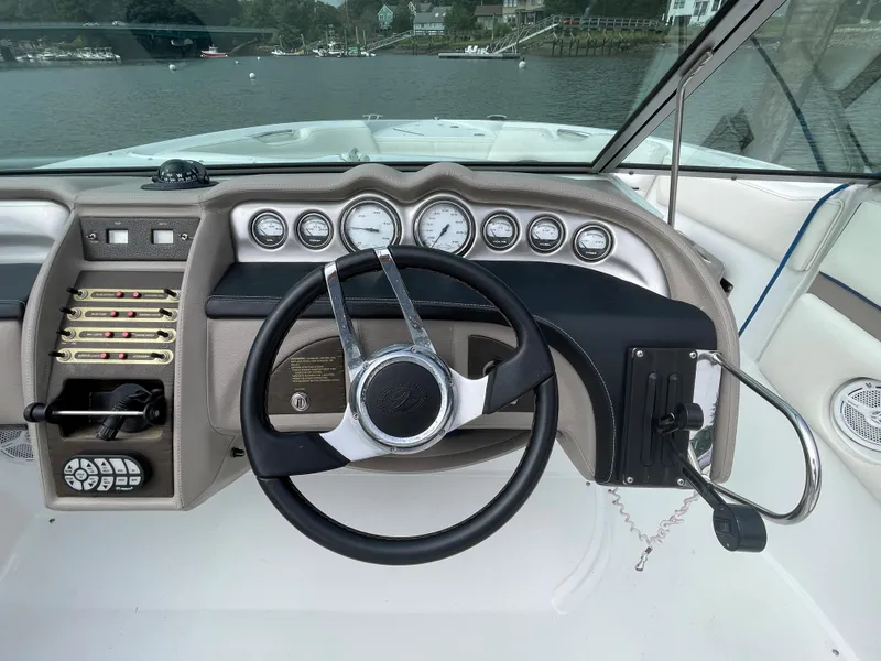 Slide: The Image of 2006 Cobalt 24SX boat dashboard with steering wheel and gauges. - 15