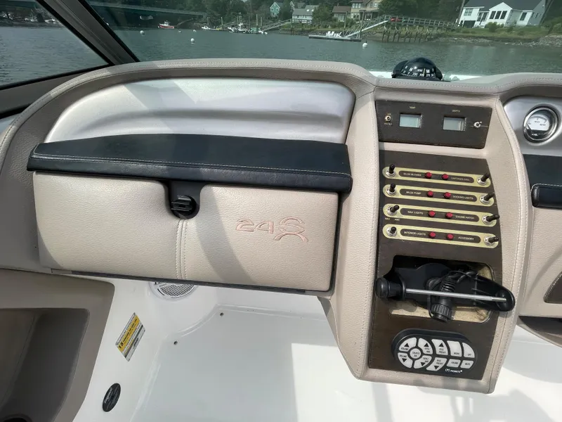 Slide: The Image of 2006 Cobalt 24SX boat dashboard with control panel and glove compartment. - 17
