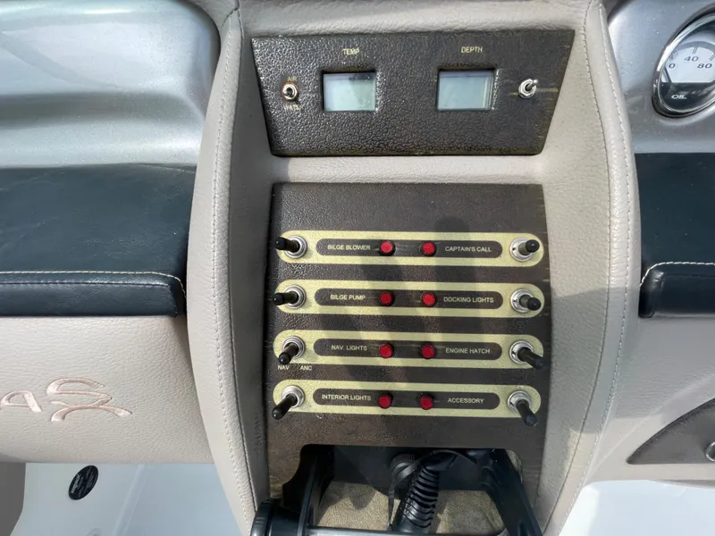 Slide: The Image of Control panel of a 2006 Cobalt 24SX boat with switches and gauges. - 19
