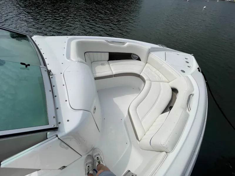Slide: The Image of 2006 Cobalt 24SX boat with white leather seating on calm water. - 21