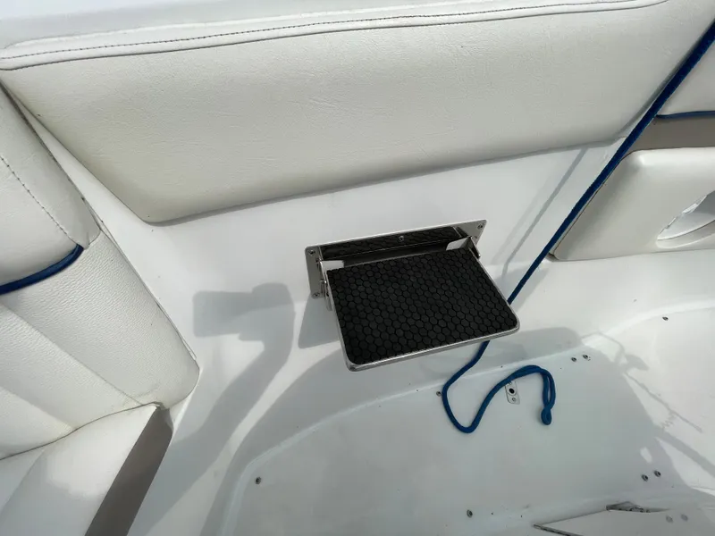 Slide: The Image of 2006 Cobalt 24SX boat interior with foldable step and white seating. - 23