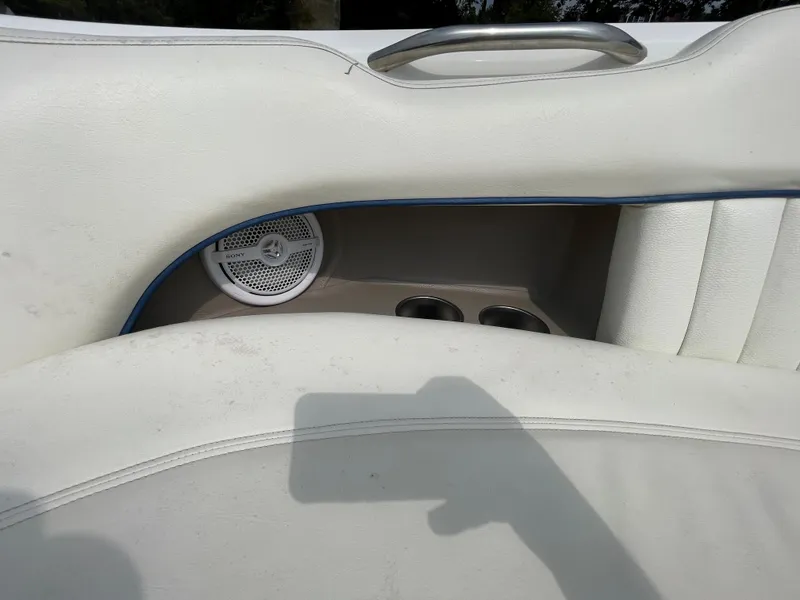 Slide: The Image of 2006 Cobalt 24SX boat interior with speaker and cup holders. - 24