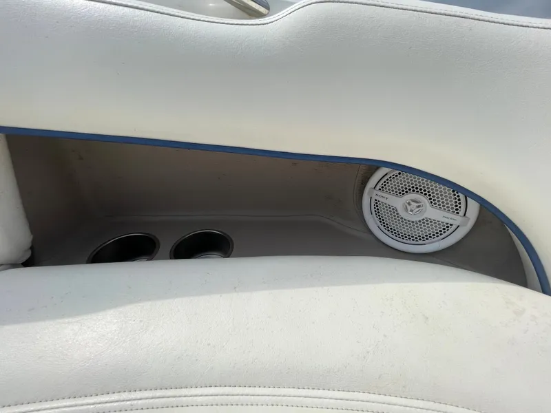 Slide: The Image of Interior of a 2006 Cobalt 24SX boat with cup holders and speaker. - 25