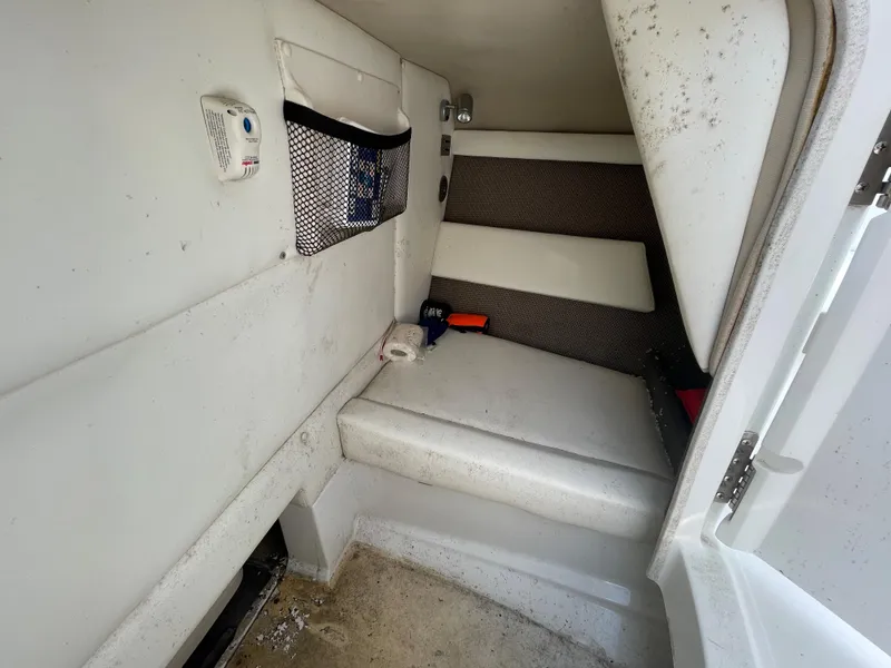 Slide: The Image of 2006 Cobalt 24SX boat cabin interior with seating and storage. - 27