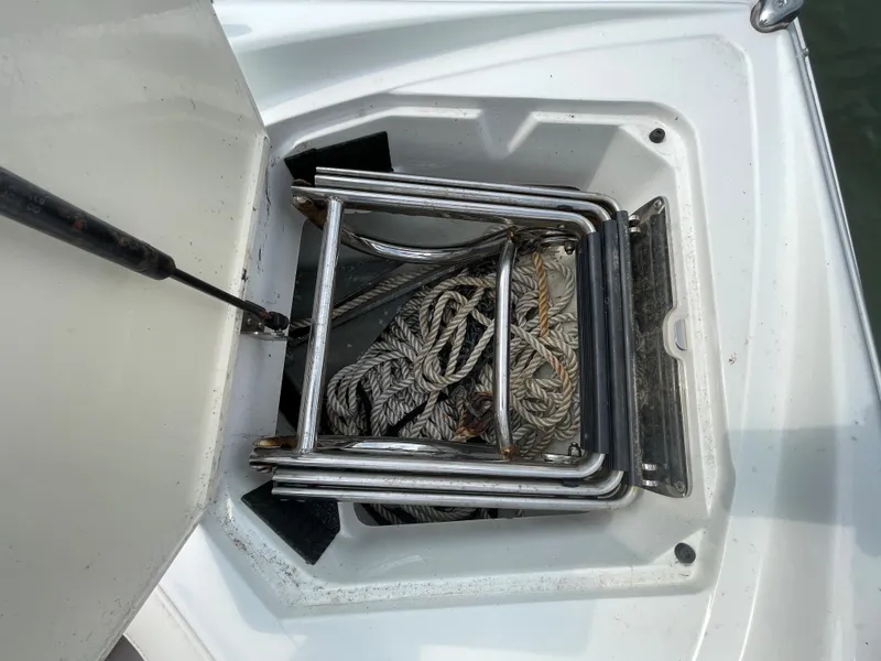 Slide: The Image of 2006 Cobalt 24SX boat anchor locker with ropes and ladder. - 31