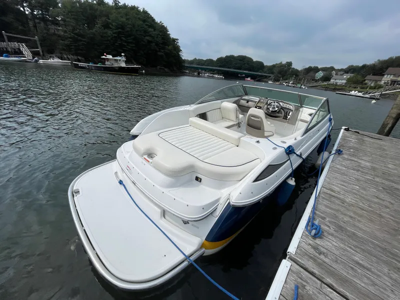 Slide: The Image of 2006 Cobalt 24SX boat docked on a calm lake. - 5