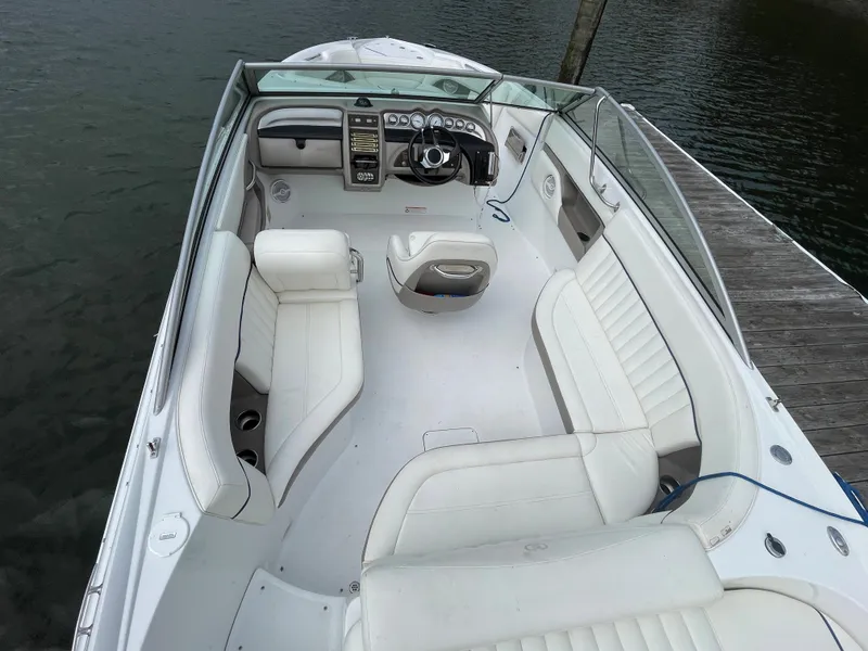 Slide: The Image of 2006 Cobalt 24SX boat with white interior, docked on calm water. - 7
