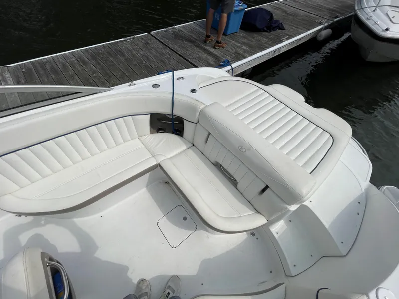 Slide: The Image of 2006 Cobalt 24SX boat interior with white leather seating at dock. - 9