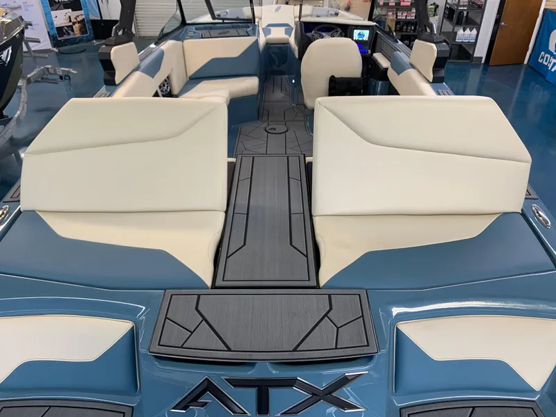 Slide: The Image of 2023 ATX Surf Boats 24 Type-S interior with blue and cream seating. - 10