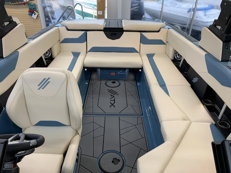 Slide: The Image of 2023 ATX Surf Boats 24 Type-S interior with beige and blue seating. - 4
