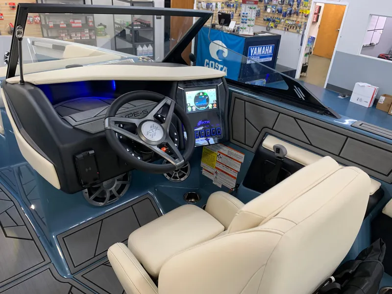 Slide: The Image of 2023 ATX Surf Boats 24 Type-S cockpit with modern steering and touchscreen controls. - 5