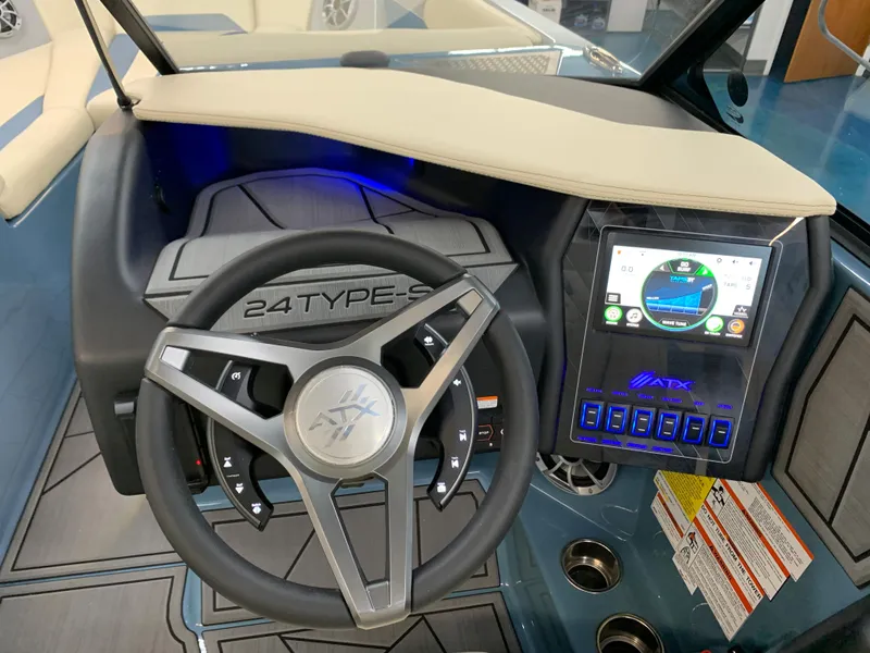 Slide: The Image of 2023 ATX Surf Boats 24 Type-S dashboard with steering wheel and touchscreen controls. - 6