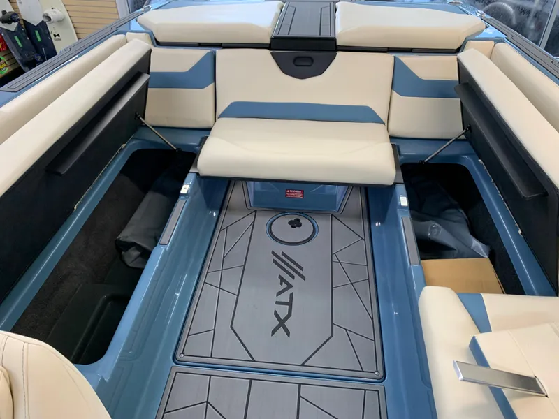 Slide: The Image of 2023 ATX Surf Boats 24 Type-S interior with blue and beige seating. - 7