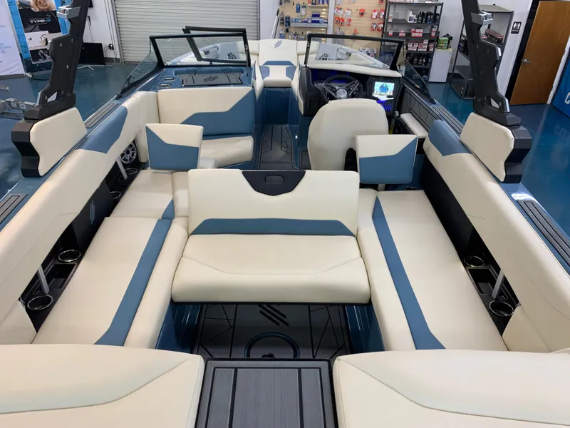 Slide: The Image of 2023 ATX Surf Boats 24 Type-S interior with beige and blue seating. - 8
