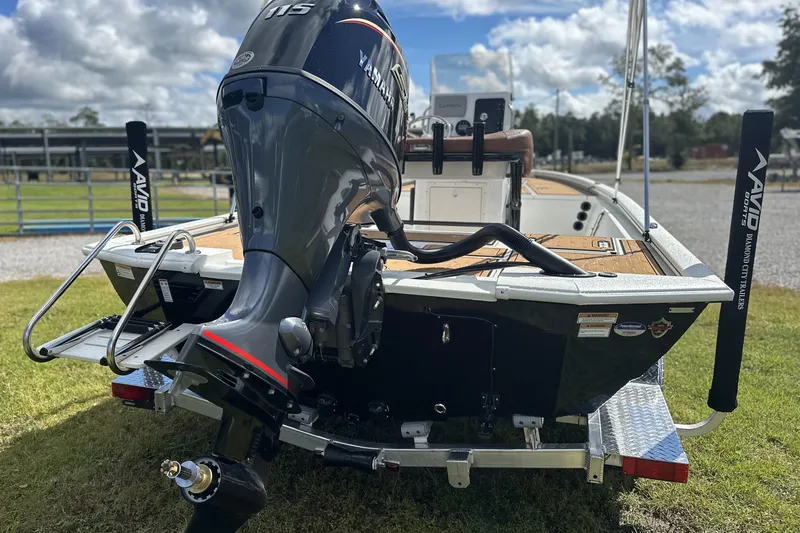 Slide: The Image of Avid 19 FSX 2026 boat with Yamaha 115 engine on a trailer. - 12