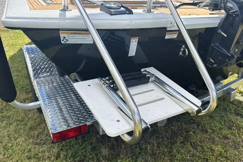 Slide: The Image of Avid 19 FSX 2026 boat with swim platform and ladder on trailer. - 13