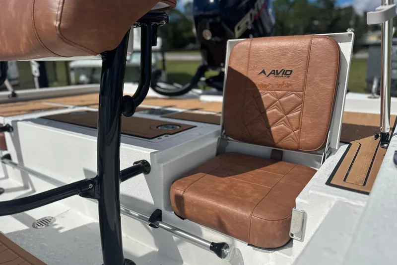 Slide: The Image of 2026 Avid 19 FSX boat with brown leather seating and sleek design. - 16