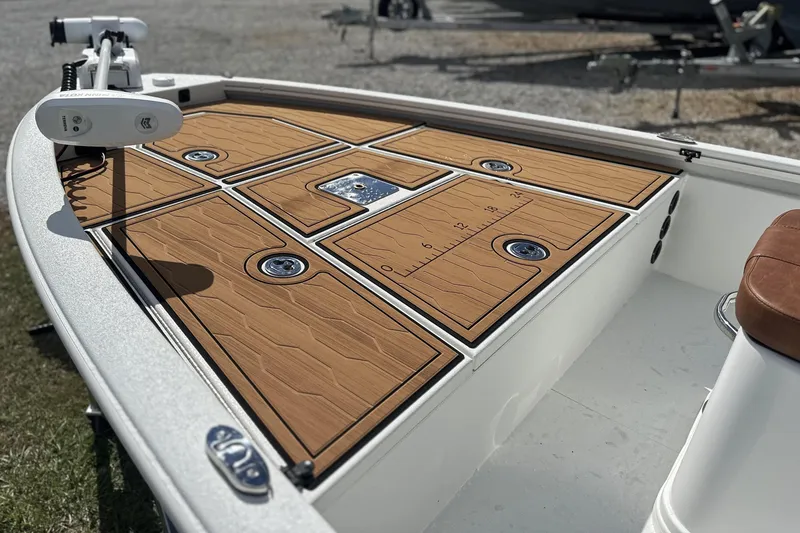 Slide: The Image of 2026 Avid 19 FSX boat deck with wood finish and storage compartments. - 19
