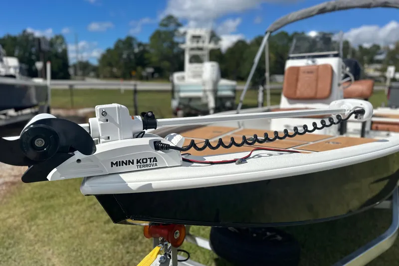 Slide: The Image of 2026 Avid 19 FSX boat with Minn Kota Terrova motor, parked outdoors. - 2