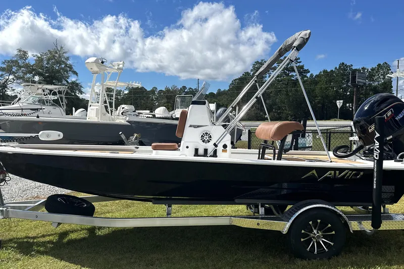 Slide: The Image of 2026 Avid 19 FSX boat on trailer, parked outdoors under a blue sky. - 3