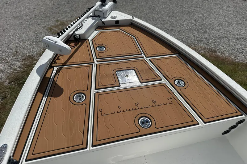 Slide: The Image of 2026 Avid 19 FSX boat deck with brown panels and measurement markings. - 5