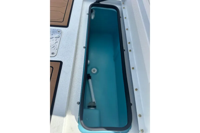Slide: The Image of 2026 Avid 19 FSX boat storage compartment with blue interior and secure sealing. - 8