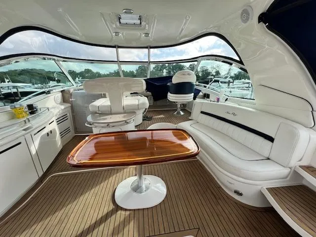 Slide: The Image of Luxurious 2005 Sea Ray 500 Sundancer yacht interior with elegant seating and wooden table. - 13