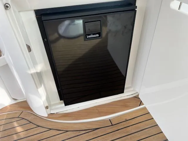 Slide: The Image of Built-in fridge on 2005 Sea Ray 500 Sundancer yacht with teak flooring. - 15