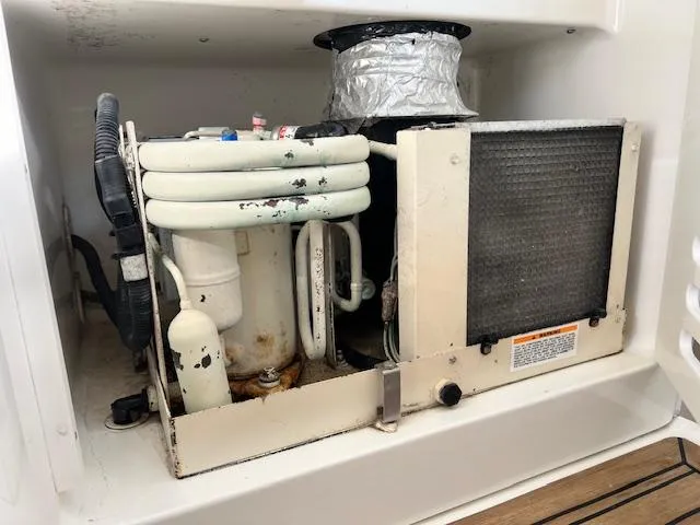 Slide: The Image of 2005 Sea Ray 500 Sundancer air conditioning unit with visible coils and ductwork. - 17