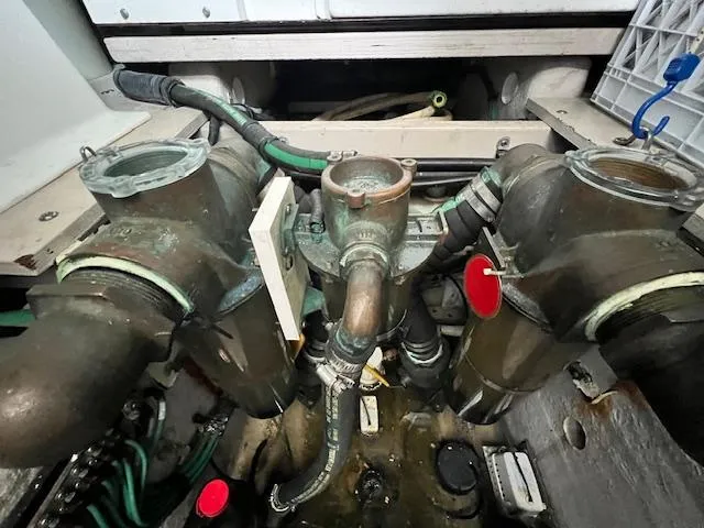 Slide: The Image of Engine room of 2005 Sea Ray 500 Sundancer, showcasing complex piping and mechanical components. - 21