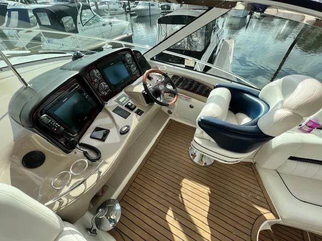 Slide: The Image of Helm of 2005 Sea Ray 500 Sundancer with modern controls and luxurious seating. - 27