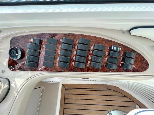 Slide: The Image of Control panel of a 2005 Sea Ray 500 Sundancer yacht with multiple switches. - 29