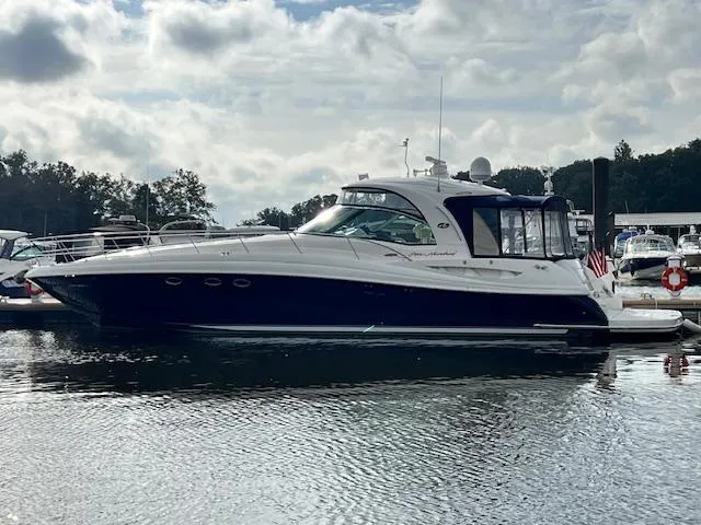 Slide: The Image of 2005 Sea Ray 500 Sundancer yacht docked on a calm, reflective water surface. - 3