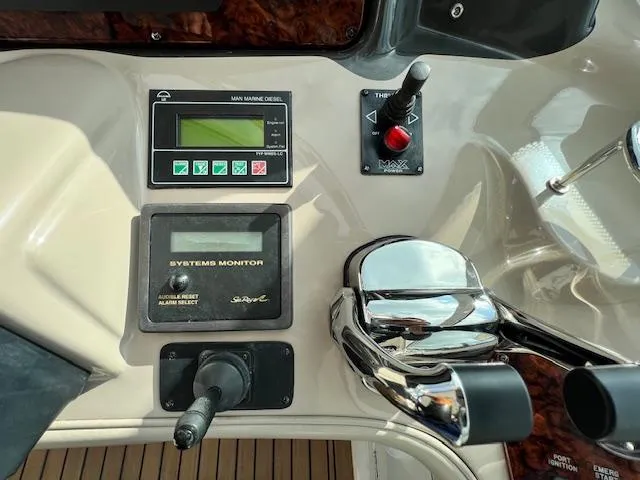 Slide: The Image of Control panel of a 2005 Sea Ray 500 Sundancer boat with system monitor and throttle controls. - 30