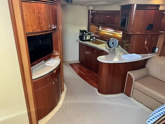 Slide: The Image of Luxurious interior of 2005 Sea Ray 500 Sundancer yacht with modern kitchen and seating area. - 40