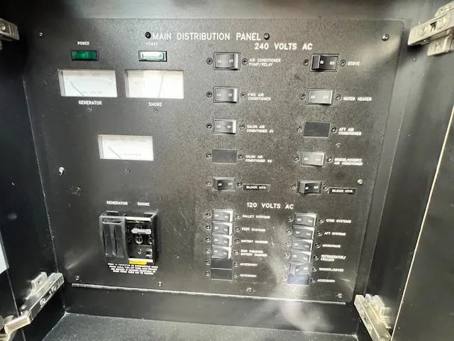 Slide: The Image of Main distribution panel of 2005 Sea Ray 500 Sundancer, showing 240V and 120V AC switches. - 43