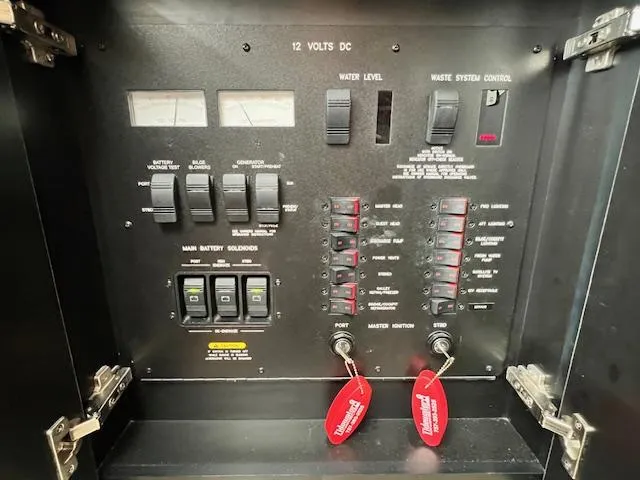 Slide: The Image of Control panel of a 2005 Sea Ray 500 Sundancer boat, featuring switches and gauges. - 44
